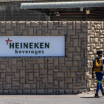 Man walks past entrance to heineken-Distell