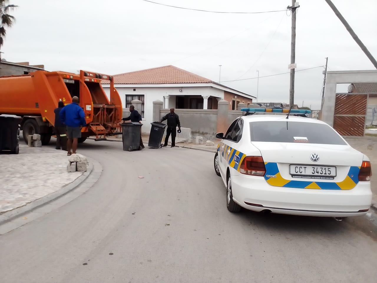 Rubbish collectors escorted by police in Philippi.